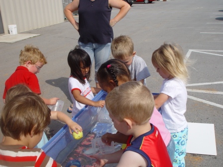 Kasen and classmates playing at the water table